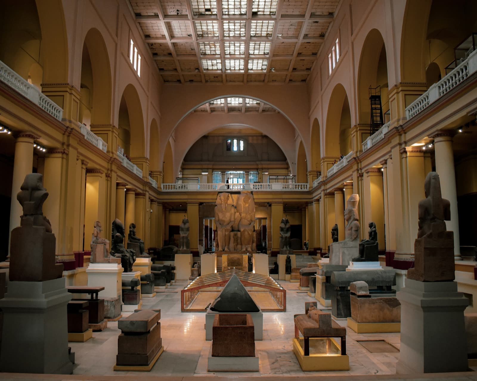 Museum gallery hall with classical statues and arched columns