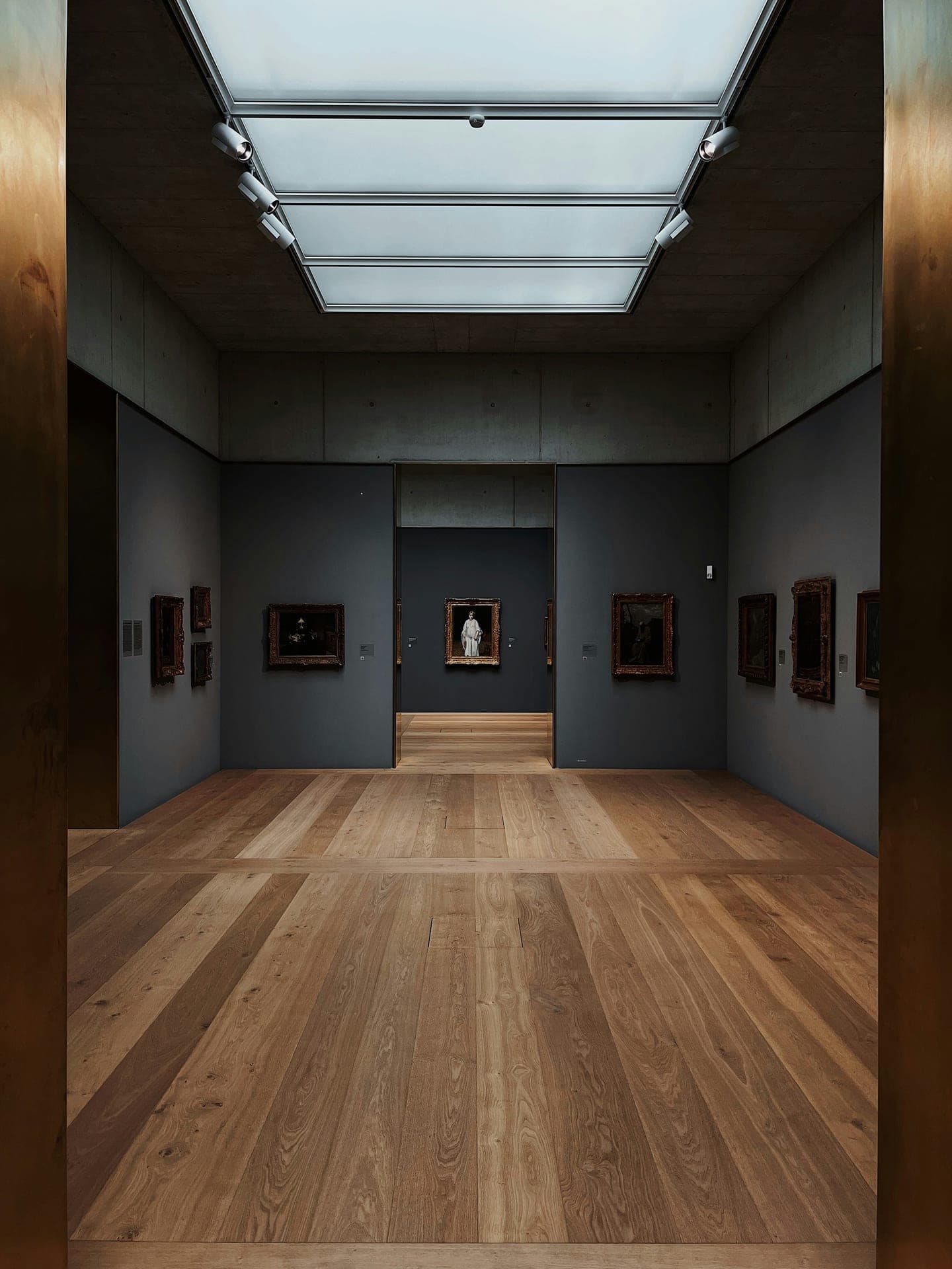 Museum gallery hall with classical statues and arched columns